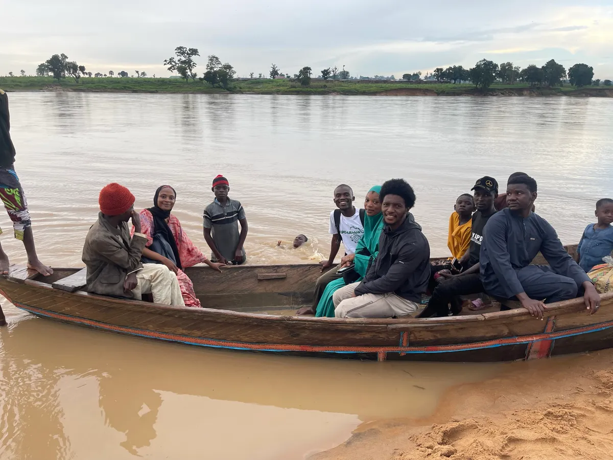 YAPD4Africa team crossing a river by boat to reach a remote community